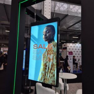 Muro UHB Double-Sided Arms Front LamasaTech Screen displaying a retail ad at an event